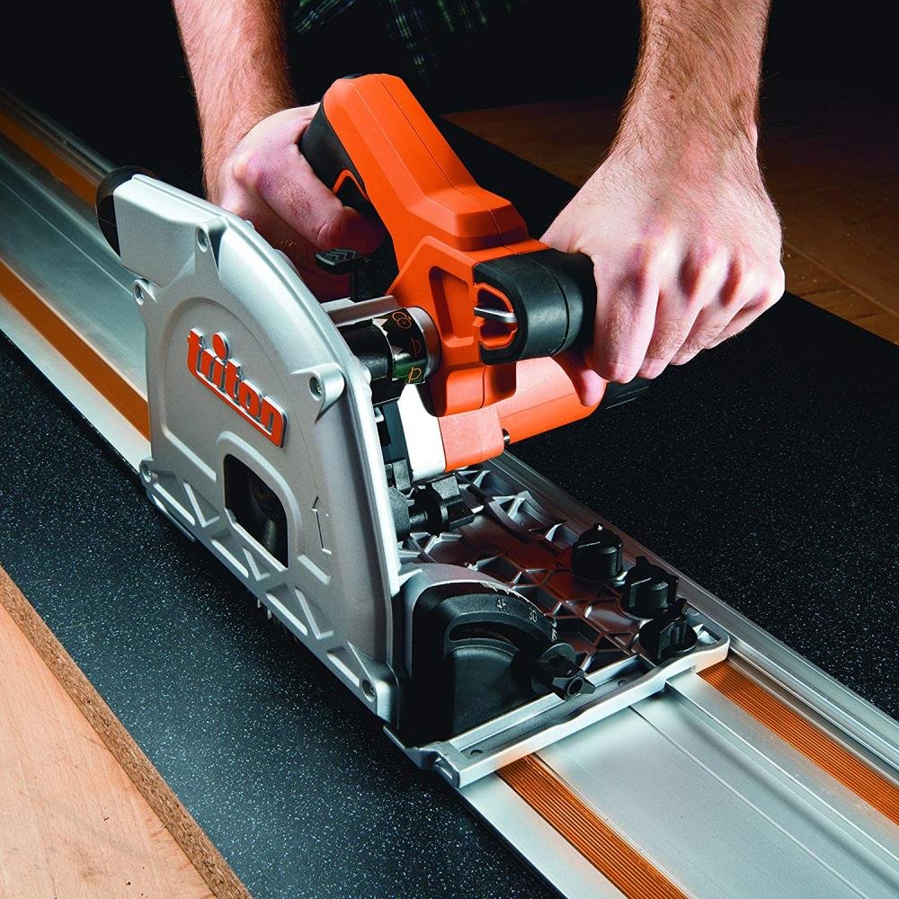 Triton TTS1400 Plunge Track Saw in action, making a precise, straight cut on a large sheet of plywood with its guide rail.