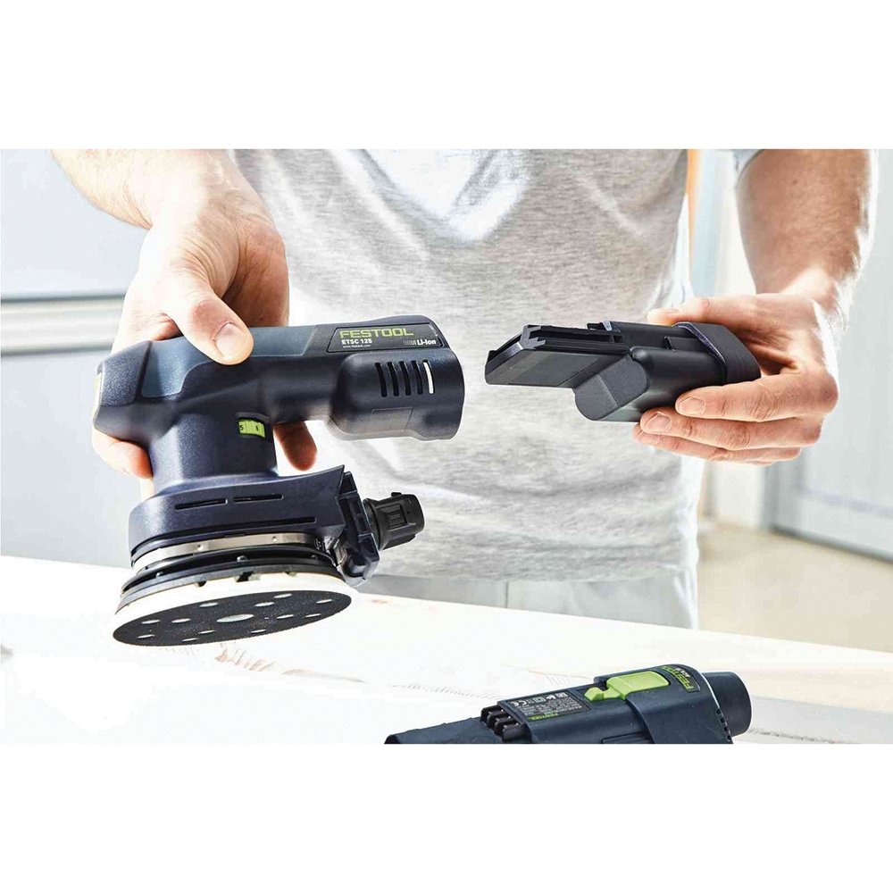 Close-up detail of the Festool ETSC 125 Li 3.1 I-Set Cordless Orbital Sander's sanding pad and dust extraction port, emphasizing its build quality.