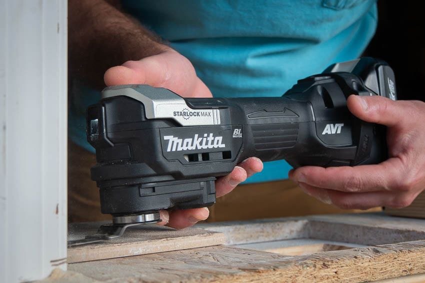 Close-up detail of the Makita XMT04Z 18V LXT Cordless Multi-Tool's Starlock accessory interface, highlighting the quick-change mechanism.