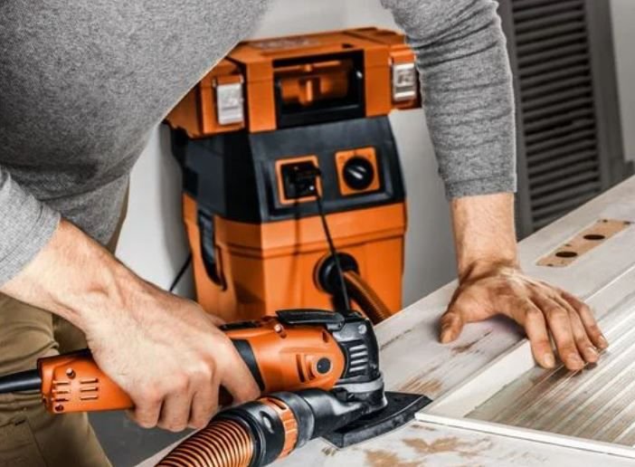 Detailed view of the Fein MultiMaster 700 FPM's Starlock accessory interface, showcasing the quick-release lever and robust attachment mechanism for secure blade changes.