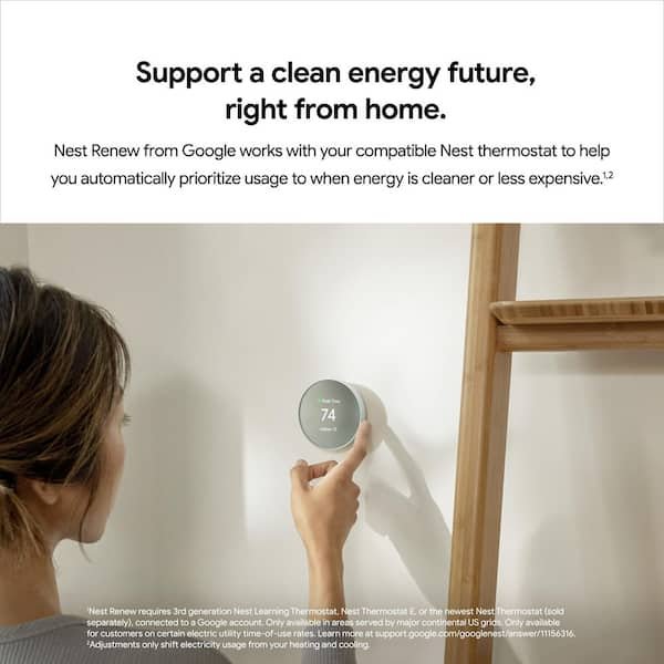 Google Nest Thermostat in Snow color, mounted on a wall, showcasing its sleek design and digital display in a modern home.