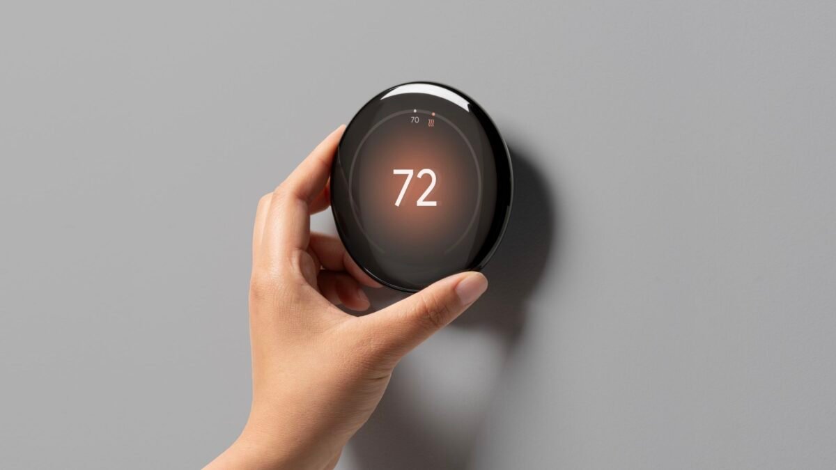 Close-up detail of the Google Nest Thermostat's intuitive side touch controls and reflective display, highlighting its user interface and sleek design.